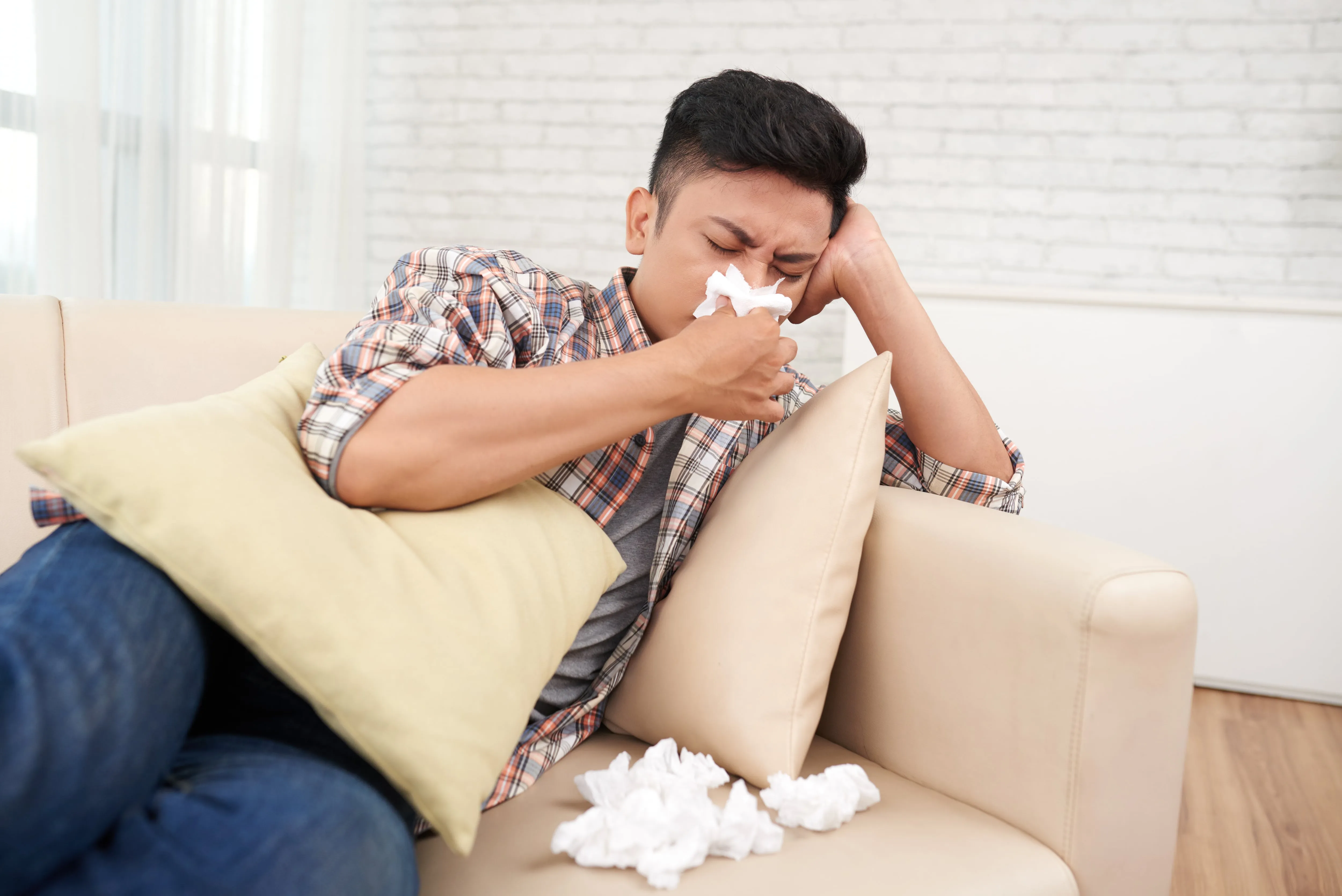 young asian man suffering runny nose having medical leave staying home min