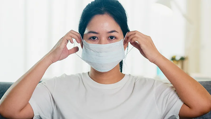 depressed asian business woman wearing protective mask sitting sofa living room house when social distancing stay home self quarantine time pandemic china coronavirus concept