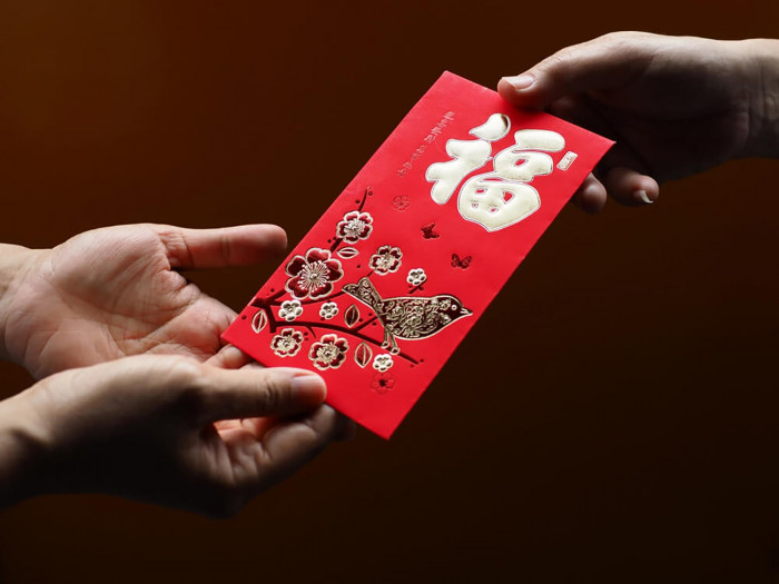 Hand Out Red Envelopes Celebrate Chinese New Year in Lumina Home by handing out red envelopes