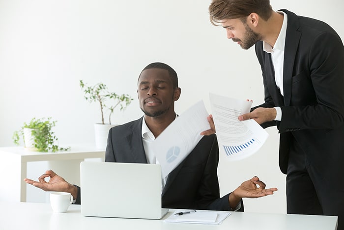 calm african american businessman practicing yoga work ignoring angry boss lumina homes house and lot for sale