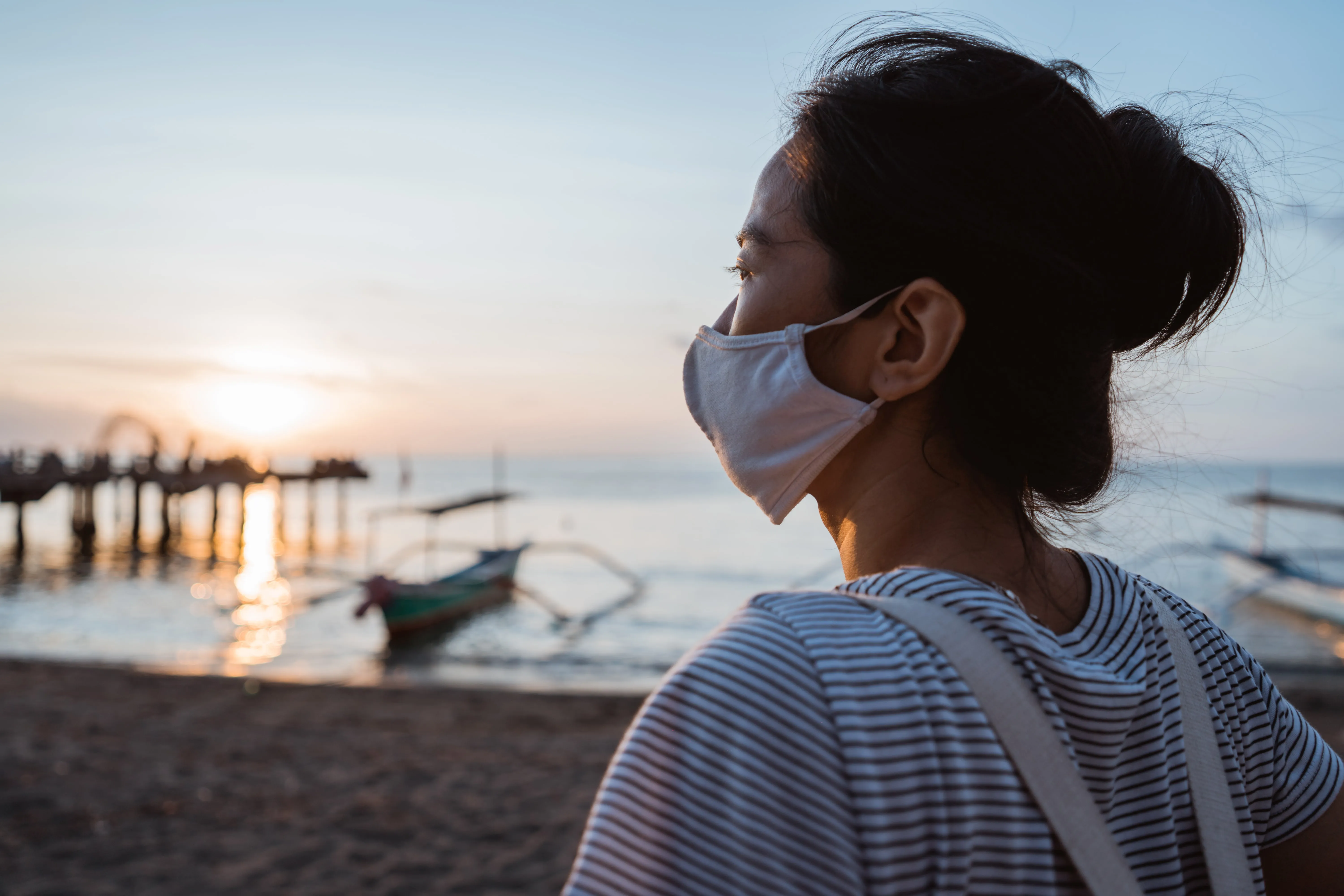 woman visiting beach with face mask healthy sunny morning min